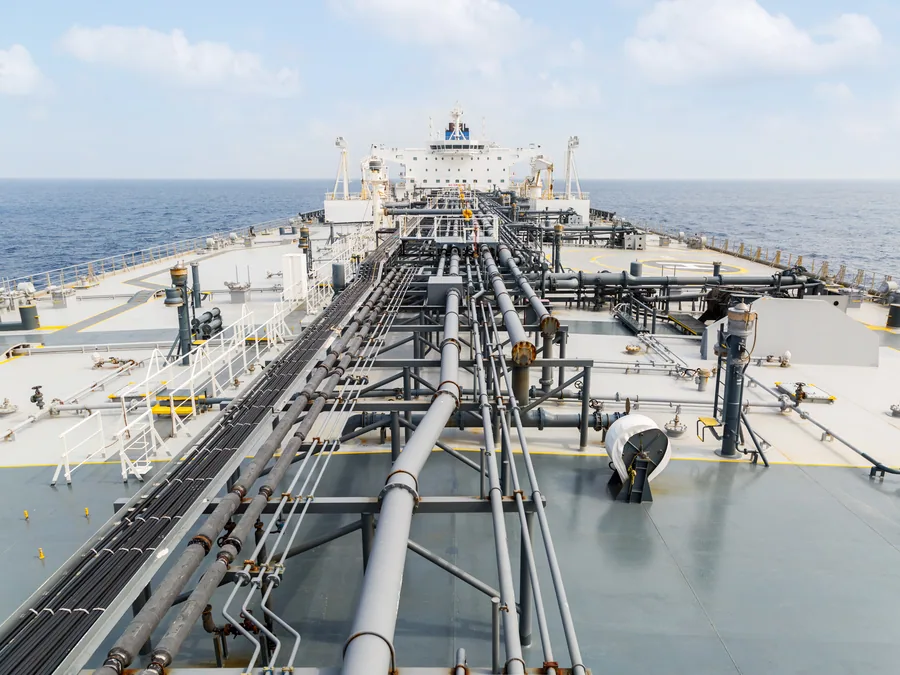 Cargo deck pipelines and manifold of a product tanker at sea.