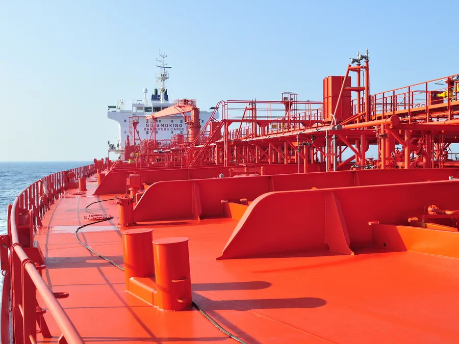Foredeck and cargo pipework of a product tanker under way at sea.